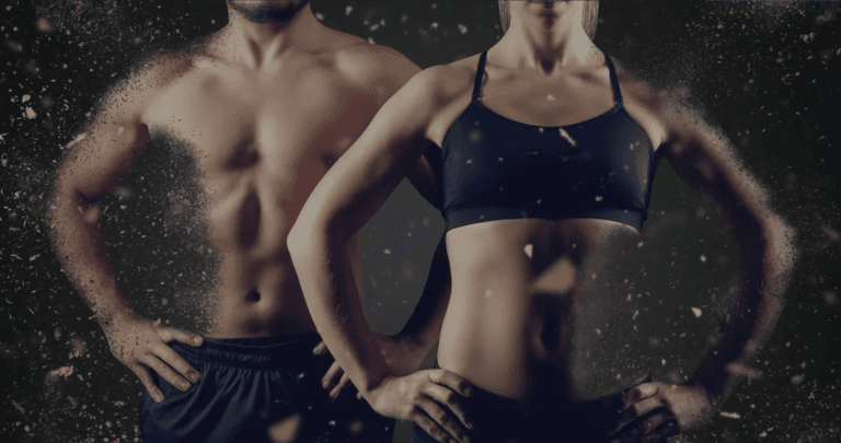 Ein fitter Mann und eine fitte Frau in Sportkleidung stehen mit den Händen in den Hüften Seite an Seite und präsentieren ihre straffen Bauchmuskeln und muskulösen Körper vor einem dunklen Hintergrund mit Staubeffekt im Strong Body Center in Pfäffikon.